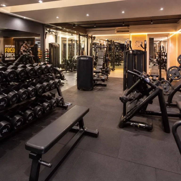 Interior de academia em São Bento do Sul, com equipamentos de musculação e área de treino funcional
